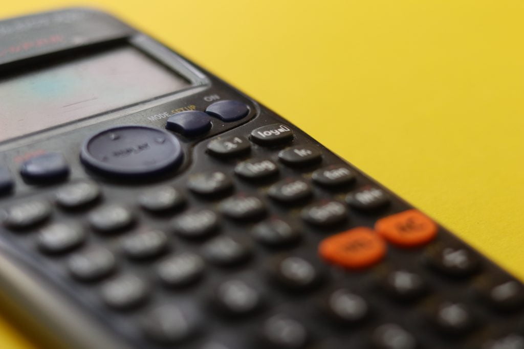 Calculator on a yellow background.