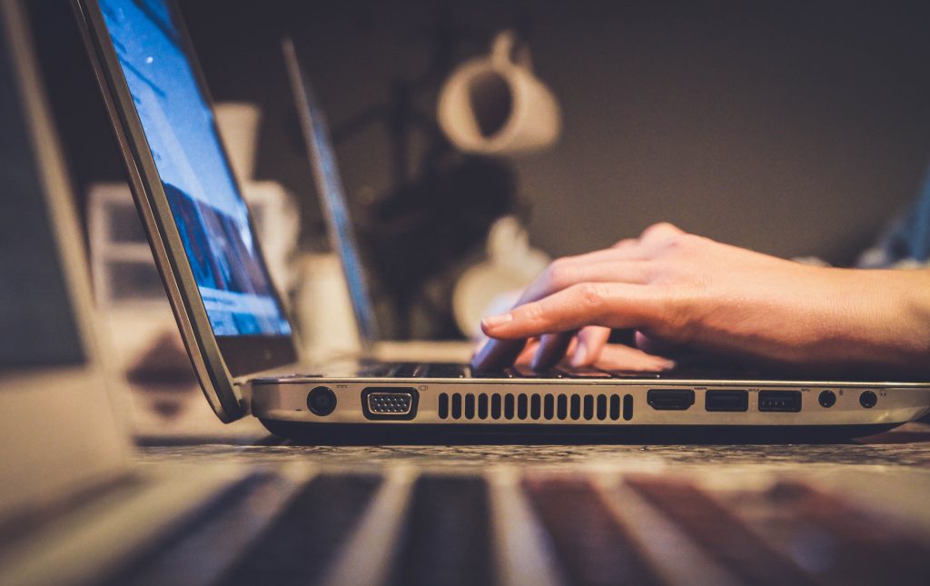 student typing on a laptop