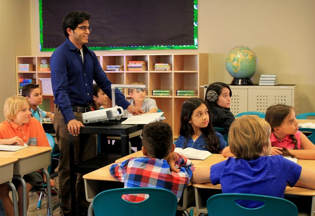Children learning with audio-visual aids.